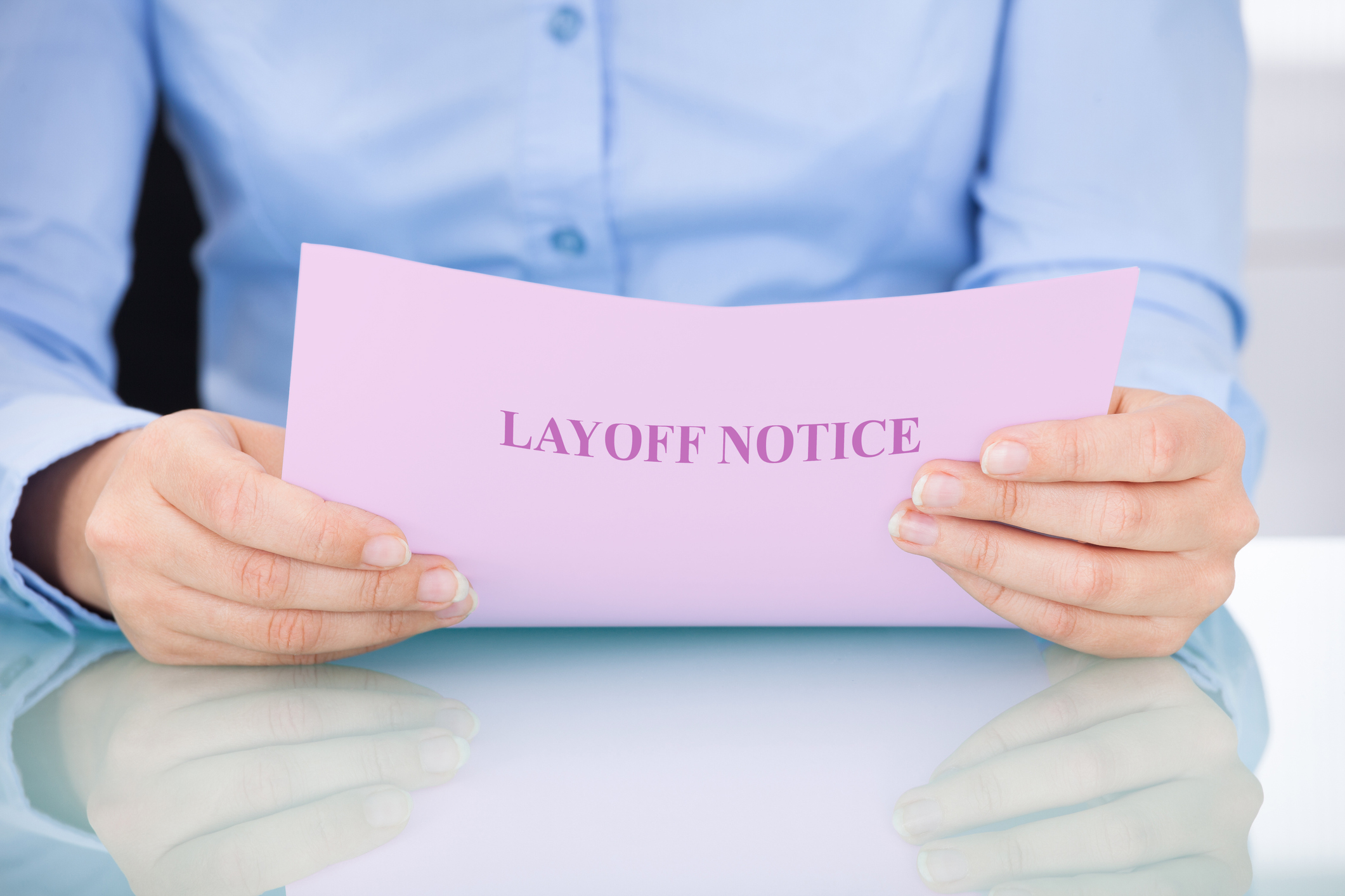 businesswoman-reading-layoff-notice-514439471_2122x1415